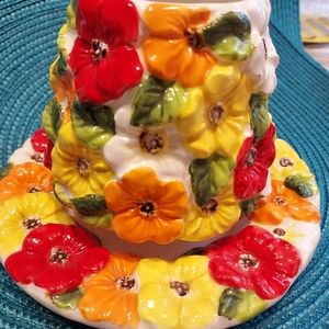 Vintage candle holder decorated with colorful pansies
